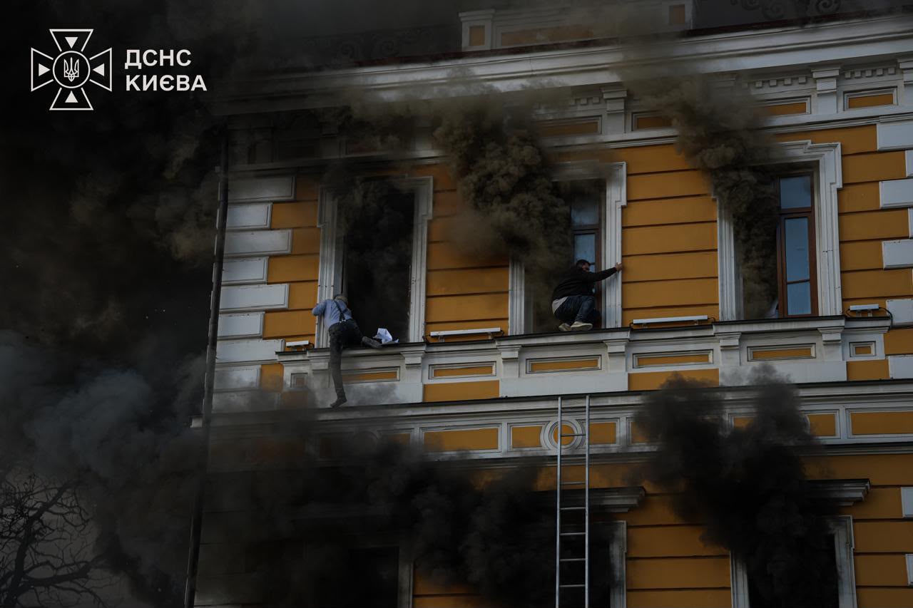 An ordinary day in Kyiv can turn into a fight for survival in seconds. People climb out of the windows of the burning National Academy of Sciences building in Kyiv, escaping the fire after a Russian strike. Photo credit: SES Kyiv